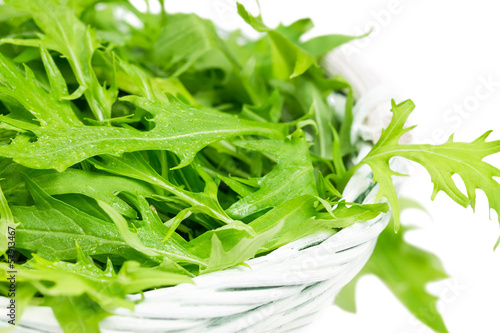 Photo: Arugula salad in a wicker basket Arugula salad in a wicker basket