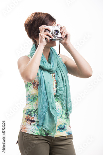 Photo: Woman taking a photo with a vintage camera Woman taking a photo with a vintage camera