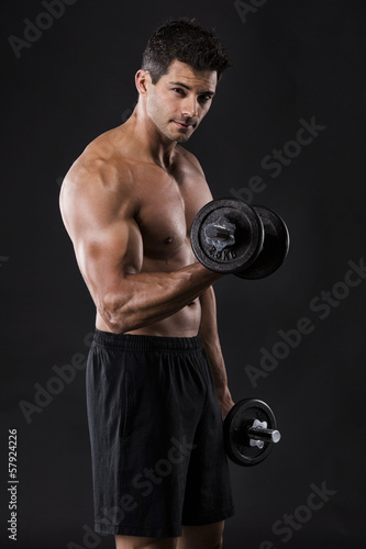 Photo: Muscular man lifting weights Muscular man lifting weights