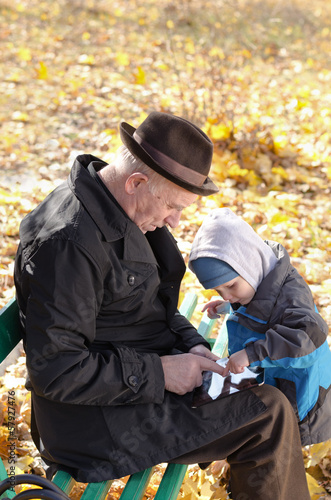 Photo: Grandfather and grandson sharing a tablet-pc Grandfather and grandson sharing a tablet-pc