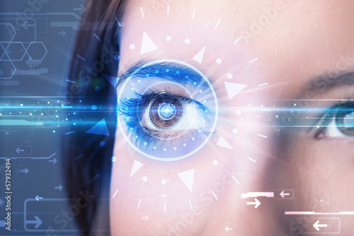 Photo: Cyber girl with technolgy eye looking into blue iris Cyber girl with technolgy eye looking into blue iris