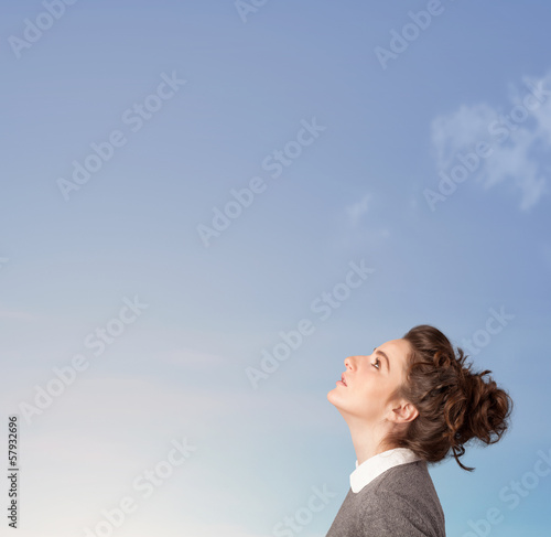 Photo: Girl looking at the blue sky copyspace Girl looking at the blue sky copyspace