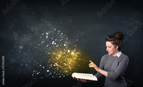 Photo: Young lady reading a magical book Young lady reading a magical book