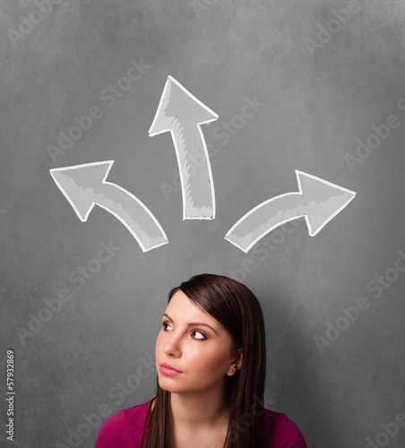 Photo: Young woman thinking with arrows above her head Young woman thinking with arrows above her head