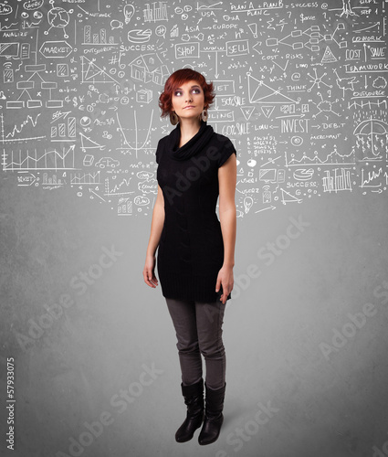 Photo: Young pretty lady with hand drawn calculations and icons Young pretty lady with hand drawn calculations and icons