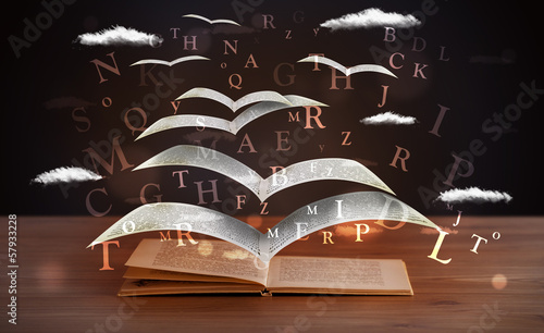 Photo: Pages and glowing letters flying out of a book Pages and glowing letters flying out of a book