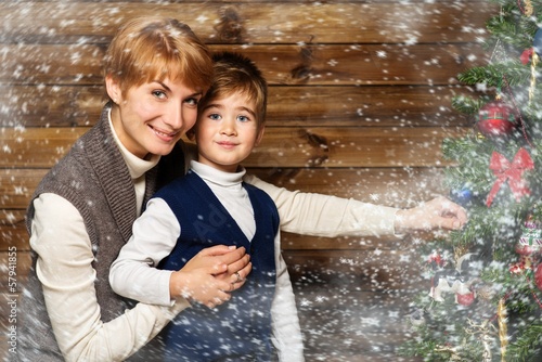 Photo: Happy mother and her lIttle boy decorating christmas tree Happy mother and her lIttle boy decorating christmas tree