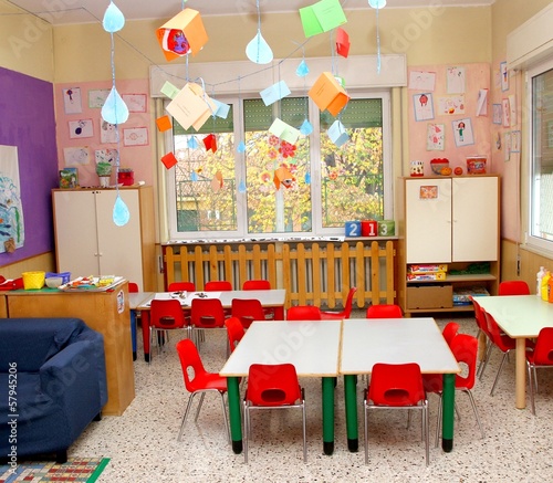 Photo: classroom in a kindergarten with tables and red chairs classroom in a kindergarten with tables and red chairs
