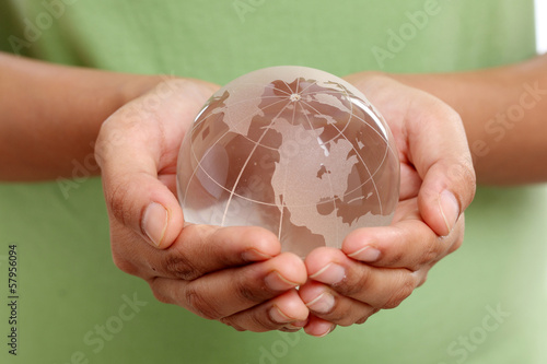 Photo: Closeup of glass globe in woman hands Closeup of glass globe in woman hands