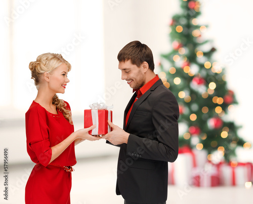 Photo: smiling woman and man with gift box smiling woman and man with gift box