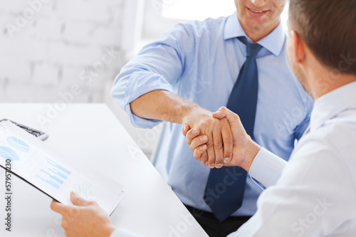 Photo: businessmen shaking hands in office businessmen shaking hands in office