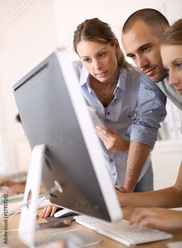 Photo: Business people working on project in office Business people working on project in office
