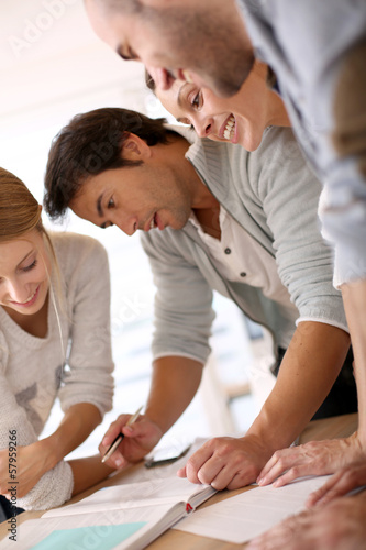 Photo: Group of business people in office working on project Group of business people in office working on project