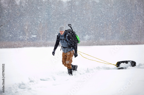 Photo: winter condition training - man + backpack walking pulling tyre winter condition training - man + backpack walking pulling tyre