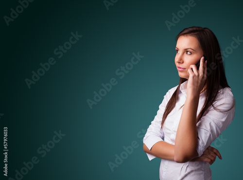 Photo: Young woman making phone call with copy space Young woman making phone call with copy space