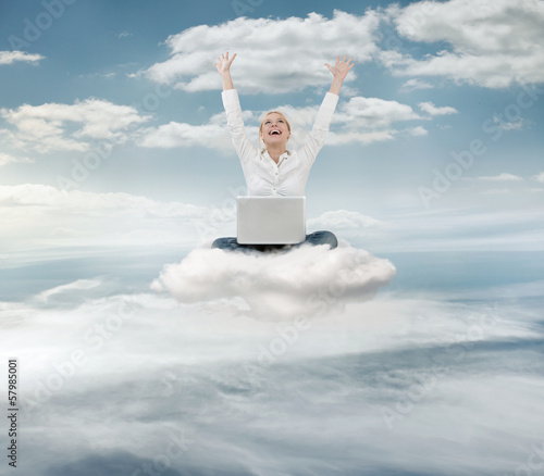 Photo: Reauccessful businesswoman with laptop on the cloud Reauccessful businesswoman with laptop on the cloud