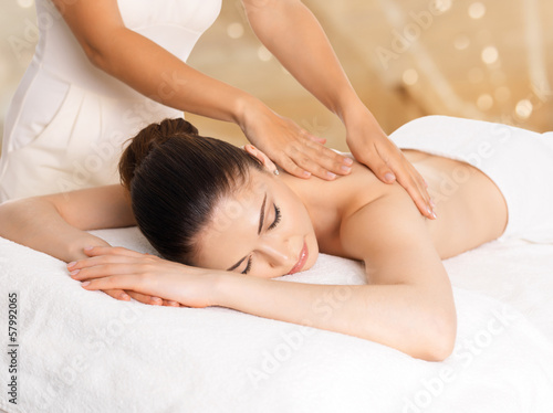 Photo: Woman having massage of body in spa salon Woman having massage of body in spa salon