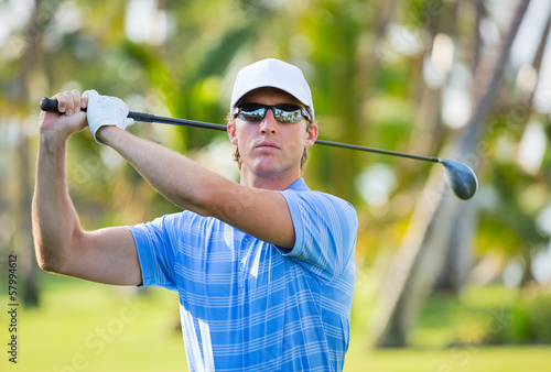 Photo: Athletic young man playing golf Athletic young man playing golf