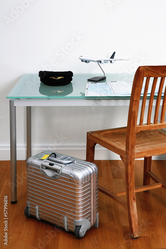 Photo: Airline pilot's desk with hat and suitcase Airline pilot's desk with hat and suitcase