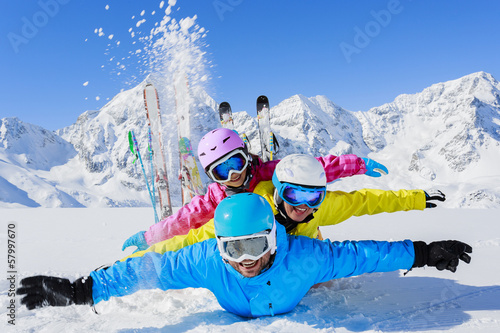 Photo: Ski, sun and fun - family enjoying winter holiday Ski, sun and fun - family enjoying winter holiday