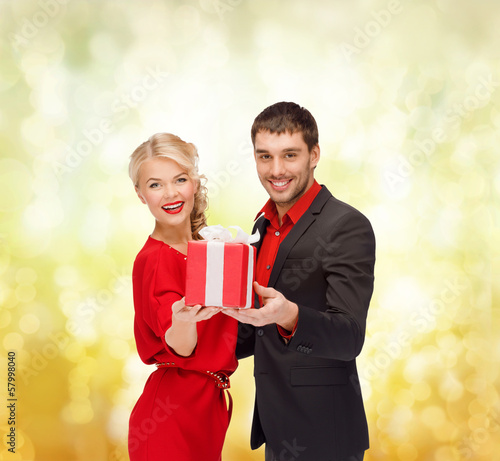 Photo: smiling woman and man with gift box smiling woman and man with gift box