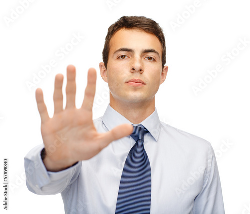 Photo: attractive buisnessman making stop gesture attractive buisnessman making stop gesture