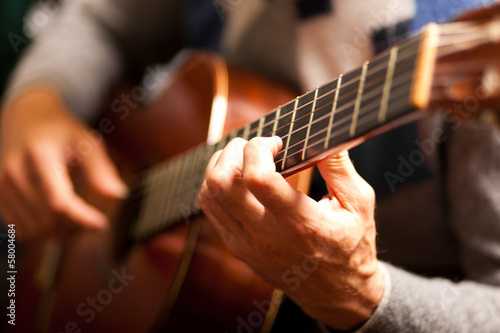Photo: Man playing guitar Man playing guitar
