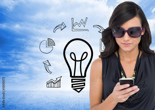 Photo: Composite image of happy brunette using smartphone Composite image of happy brunette using smartphone