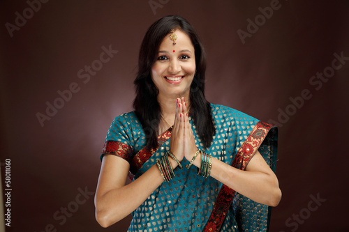 Photo: Smiling young woman greeting "Namasthe" Smiling young woman greeting "Namasthe"