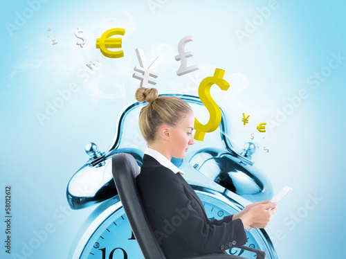 Photo: Composite image of businesswoman sitting on swivel chair with ta Composite image of businesswoman sitting on swivel chair with ta