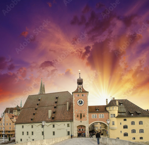 Photo: Beautiful sunset sky over medieval city skyline. Middle-Age buil Beautiful sunset sky over medieval city skyline. Middle-Age buil