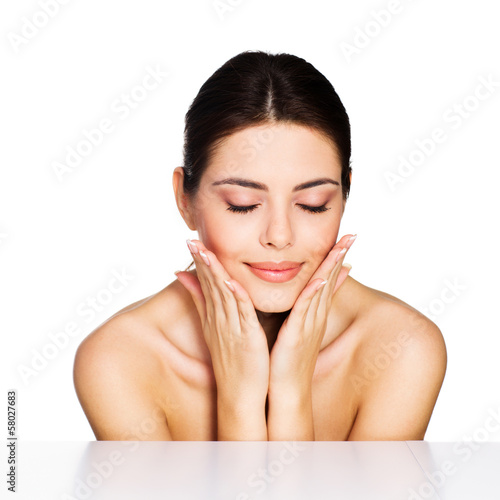 Photo: Beauty shot of a young model touching her face Beauty shot of a young model touching her face