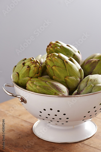 Photo: Raw pile of artichokes on colander Raw pile of artichokes on colander