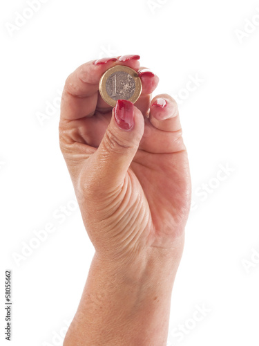 Photo: woman hand with euro coin between the fingers woman hand with euro coin between the fingers