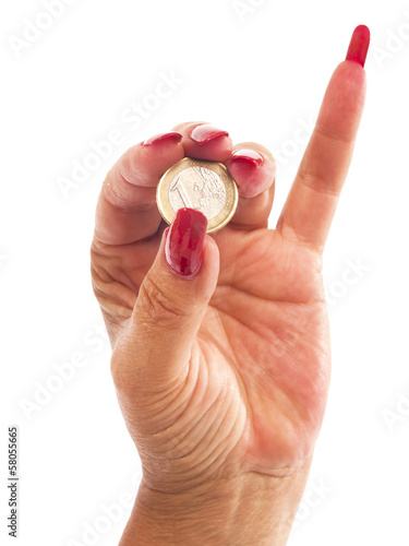 Photo: woman hand with euro coin between the fingers woman hand with euro coin between the fingers