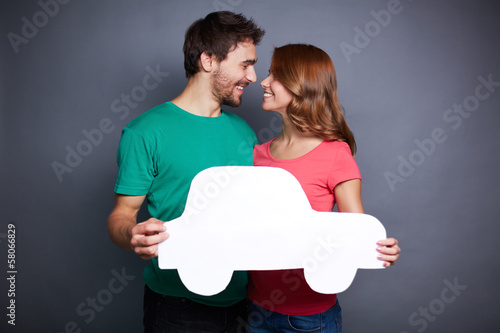 Photo: Couple with paper car Couple with paper car