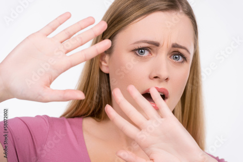 Photo: Close up of girl trying to stop something. Close up of girl trying to stop something.