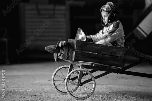Photo: Young Aviator in aircraft in a hangar Young Aviator in aircraft in a hangar