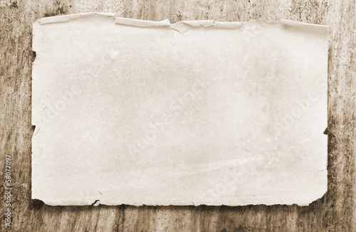 Photo: Paper on old wooden background Paper on old wooden background