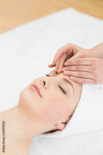 Photo: Hands massaging a beautiful woman's forehead Hands massaging a beautiful woman's forehead