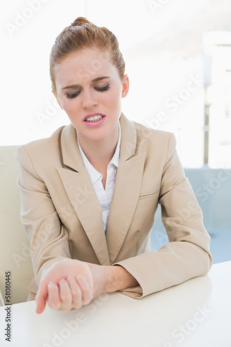 Photo: Businesswoman suffering from wrist pain Businesswoman suffering from wrist pain