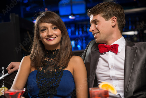 Photo: Young couple talking in a nightclub Young couple talking in a nightclub