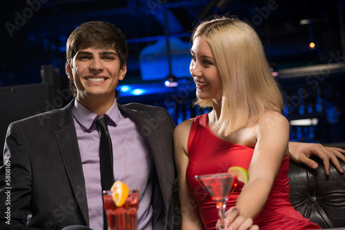 Photo: Young couple talking in a nightclub Young couple talking in a nightclub