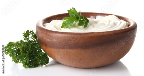 Photo: Sour cream in bowl isolated on white Sour cream in bowl isolated on white