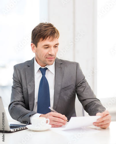 Photo: businessman with laptop computer and documents businessman with laptop computer and documents