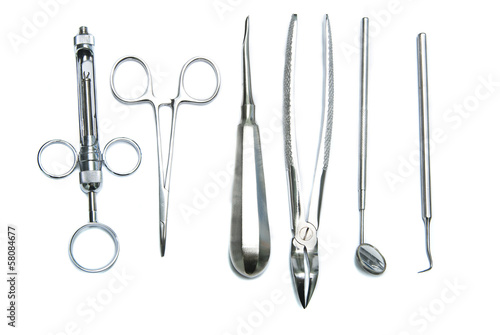 Photo: Metallic dentist tools close up in a dentist clinic. Metallic dentist tools close up in a dentist clinic.