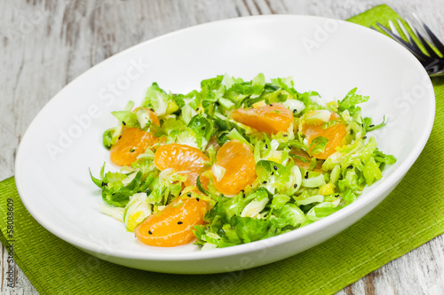 Photo: Shredded Brussels Sprout and Tangerine Salad., close up. Macro. Shredded Brussels Sprout and Tangerine Salad., close up. Macro.
