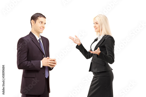 Photo: Two businesspeople having conversation together Two businesspeople having conversation together