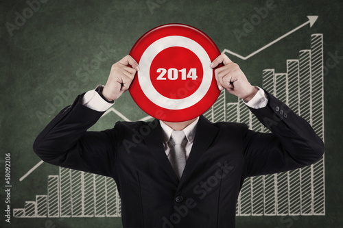 Photo: Businessman holding a dartboard Businessman holding a dartboard