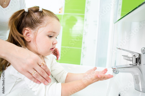 Photo: kid washing hands with adult kid washing hands with adult